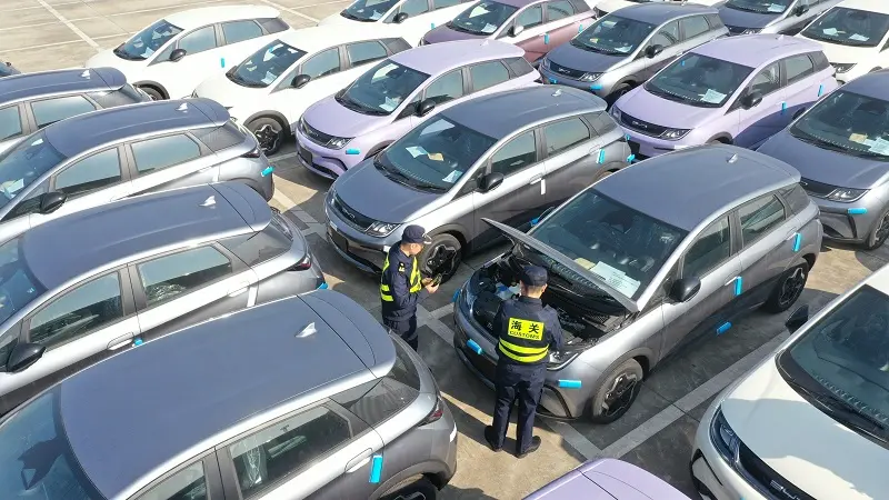 Customs officers at Shanghai Waigaoqiao Port inspect exported new energy vehicles